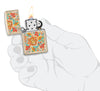 Zippo Feuerzeug Farbdruck sandfarben mit floralem Blumenmuster im Hippiestil geöffnet mit Flamme in stilisierter Hand